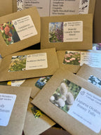 Bishy Barnabees Cottage Garden’s "Flowers Perfect for Drying Extra" features brown seed packets with colorful flower images and a printed list of varieties—ideal dried flower seeds for creating everlasting bouquets.