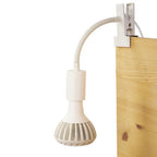White Grow Gang Stelo Gooseneck Lamp Stand clipped to a wooden board with a grow bulb