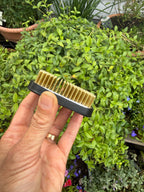 Rectangular Kenzan Flower Frog held edge-on showing brass pins