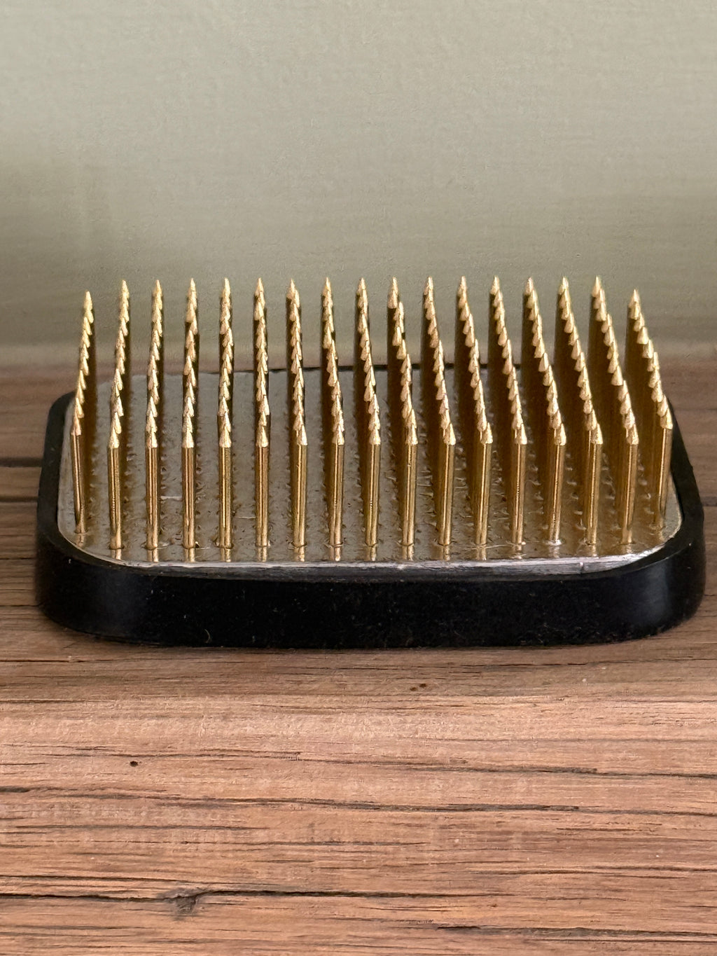 Medium rectangular Kenzan Flower Frog, angled view of its dense brass pins