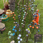 Rows of glass ball garden stakes in many colours