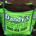 A large green bag of Topsoil Welsh VegeGrow® for vegetables from Dandy's Topsoil & Landscape Supplies, listing products like turf, gravel, bark, compost, sand, and rock salt, with contact details and website.