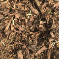 A close-up of Landscaping Garden Bark Mulch by Dandy's Topsoil & Landscape Supplies, showing various sizes and rough textures, ideal for gardening or landscaping.