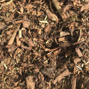 A close-up of Landscaping Garden Bark Mulch by Dandy's Topsoil & Landscape Supplies, showing various sizes and rough textures, ideal for gardening or landscaping.