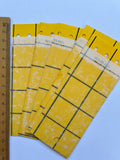 Mini Yellow Eco Traps – four yellow sticky cards with grid lines beside a ruler
