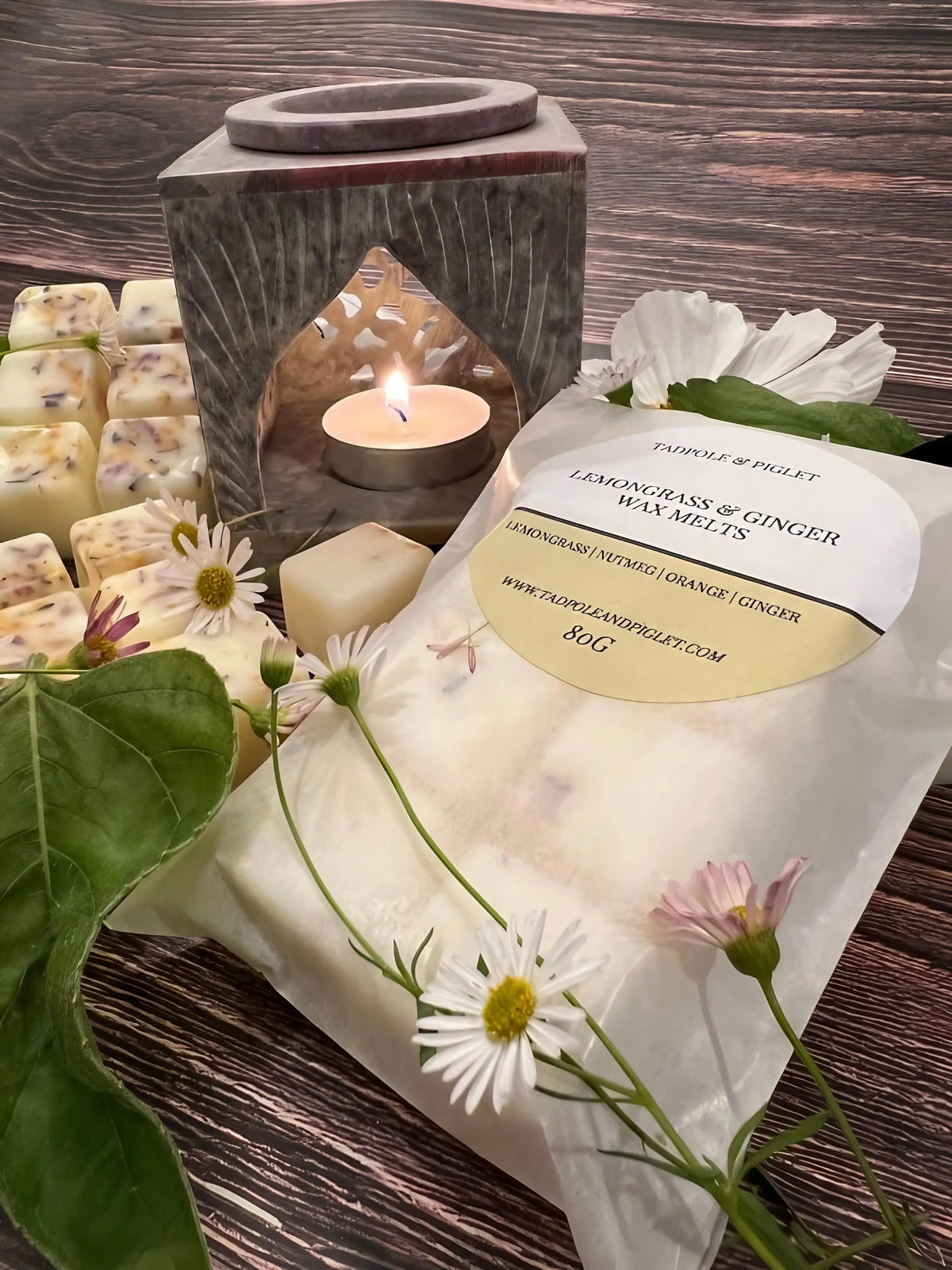Hand-carved Moroccan Arch soapstone burner with a lit tealight, wax melts, daisies and a melt packet
