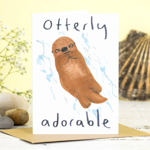 Otterly Adorable Card – cartoon otter floating on its back in blue water