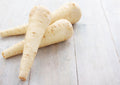 Parsnip Tender & True – three cream parsnips on a pale wooden surface
