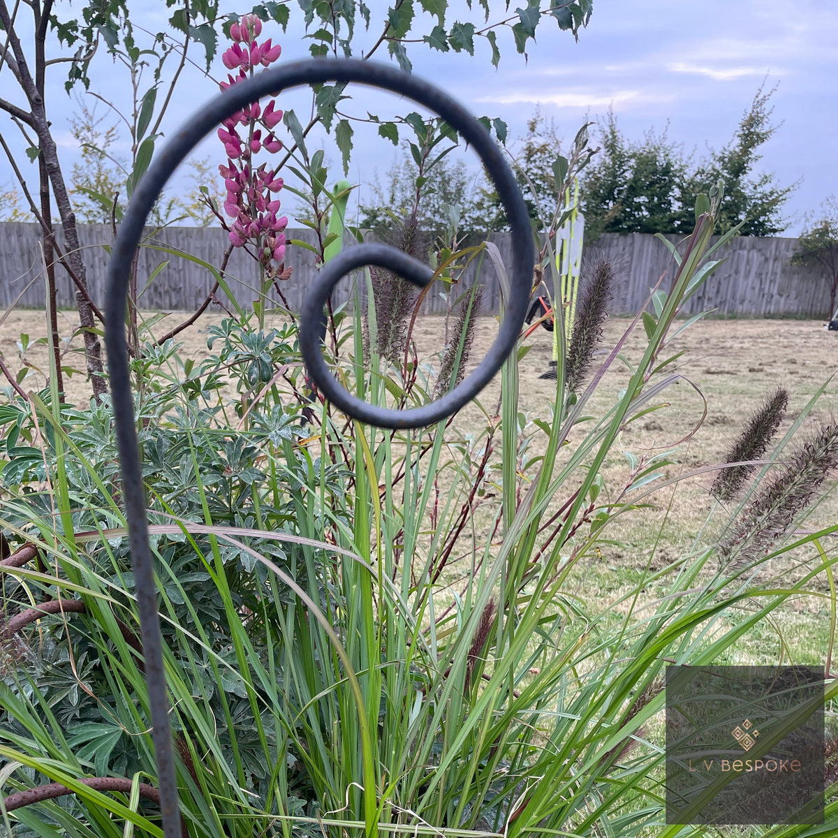 Shepherds Crook Hanger with a scroll top among grasses and lupins
