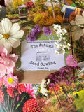 The Bishy Barnabees Cottage Garden Autumn Seed Sowing Flower Box is surrounded by colorful flowers, garden postcards, and guides to help you create your own hardy annual cutting flower patch.