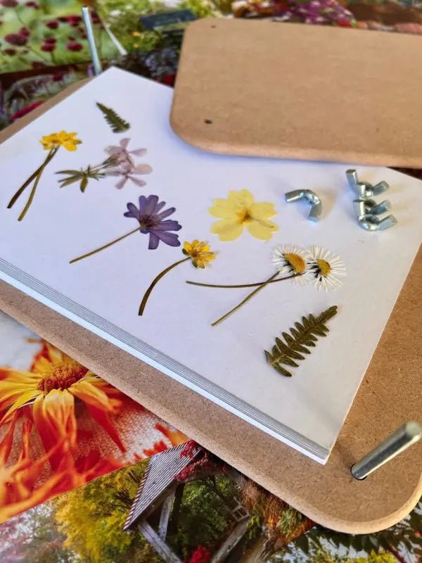 The Bishy Barnabees Cottage Garden Wooden Flower Press - Standard features bolts and wing nuts to press flowers and ferns, displayed on vibrant floral backgrounds—perfect for flower pressing enthusiasts.