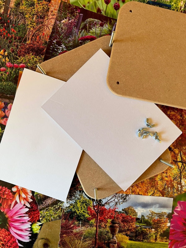 Wooden flower press components including blotting paper, MDF boards, and assembly pieces on a colorful floral backdrop.